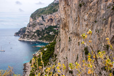 Rock formations by sea against sky