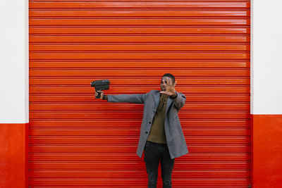 Full length of a man standing against wall