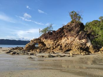 Rocks on beach against sky