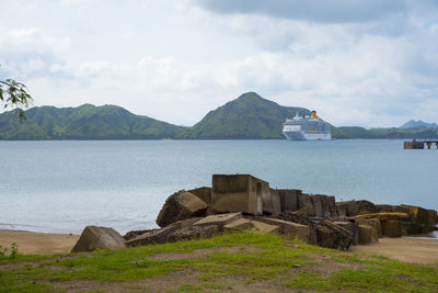 Scenic view of sea and mountains against sky