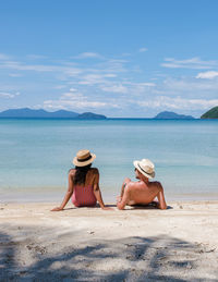 Koh mak thailand,a couple of men and woman on the beach, panoramic view of idyllic beach in thailand