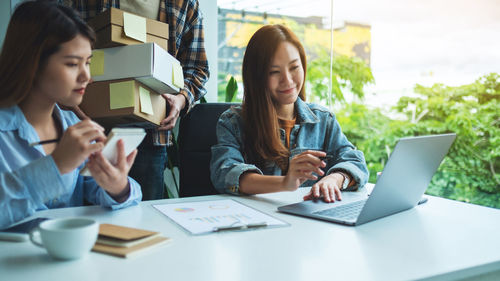 Businesswoman using laptop on table