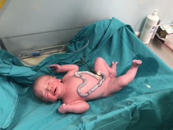 High angle view of baby sleeping on bed