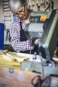 Senior woman working in factory