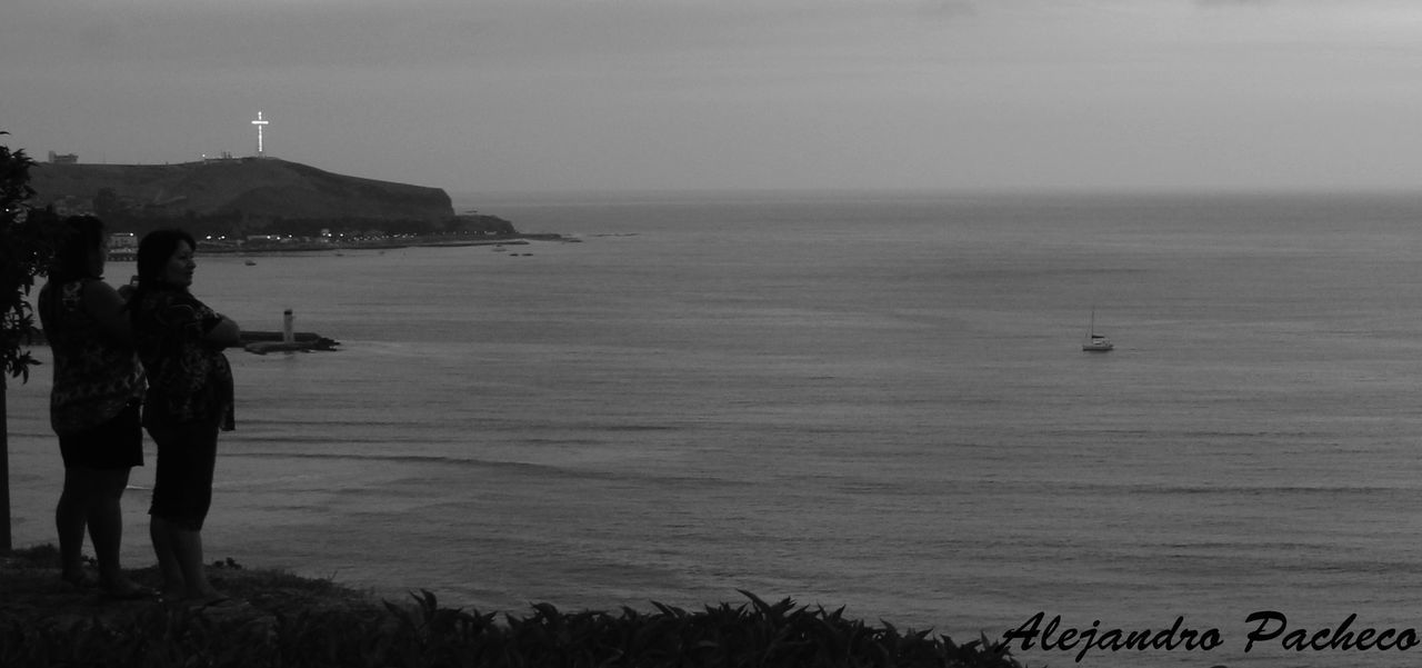 SCENIC VIEW OF SEA WITH MOUNTAIN IN BACKGROUND