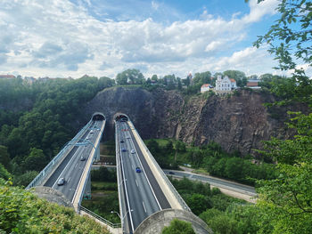 High angle view of road amidst trees against sky