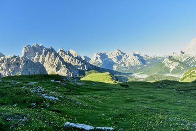 Scenic view of snowcapped mountains against clear blue sky