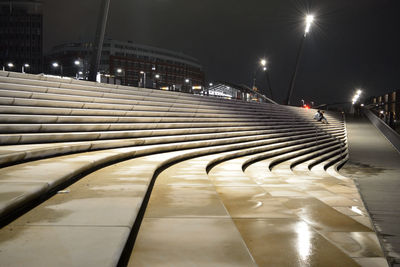 Illuminated wet steps at park in city