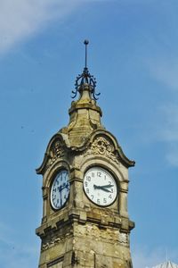 Low angle view of clock tower against sky