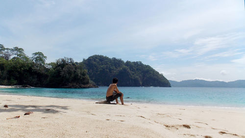 Woman on beach against sky