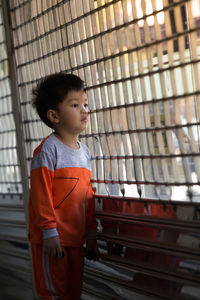 Boy looking through window