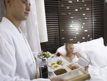 Midsection of woman sitting on table