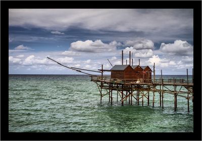 Built structure on beach against sky