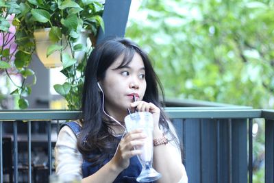 Portrait of beautiful woman drinking glass