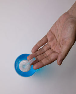 Close-up of hand holding finger against white background