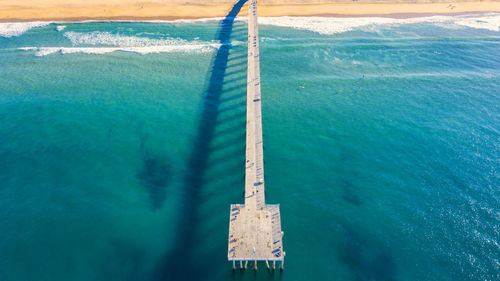 Aerial view of pier at beach over sea