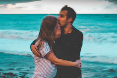 Young couple standing on beach