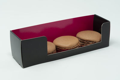 Close-up of cake in box against white background