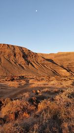 Scenic view of arid landscape against clear sky