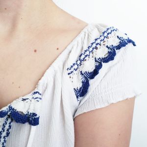 Cropped image of woman wearing top against white background