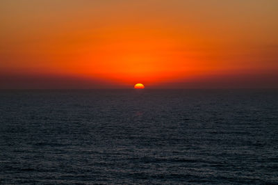 Scenic view of sea against romantic sky at sunset