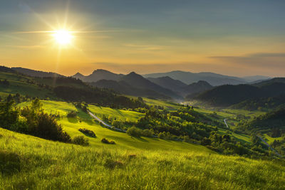 Scenic view of field against sky during sunset