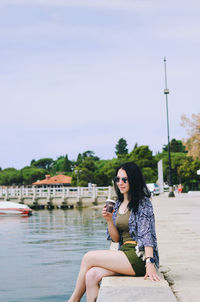 Lifestyle portrait. beautiful asian woman relaxing in sunny day at beach. summer. sea. travel