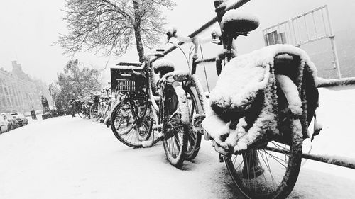 Bicycle parked on snow covered road