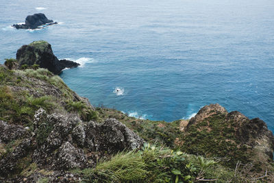 High angle view of sea by cliff