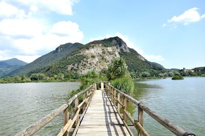 Pier over lake against sky