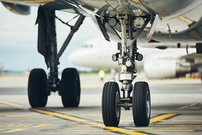 Close-up of airplane at airport runway