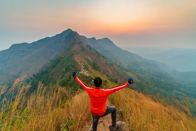 Traveler man hiking enjoying in the mountains with backpack at khao chang puak mountain thailand.