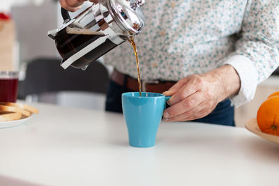 Midsection of coffee cup on table