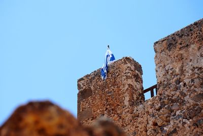 Low angle view of a flat in a building against clear blue sky