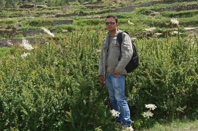 Full length of young man standing on field