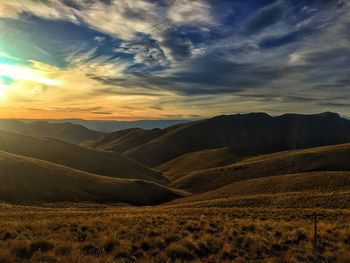 Scenic view of landscape against cloudy sky