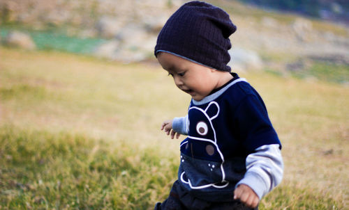 Cute baby girl standing on land