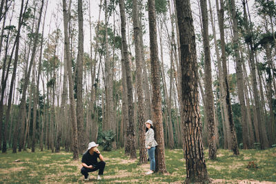 People standing by trees in forest