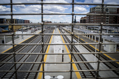 Railroad tracks in city against sky