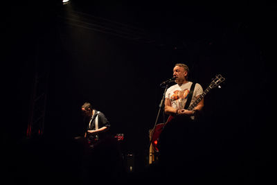 Man playing guitar in the dark