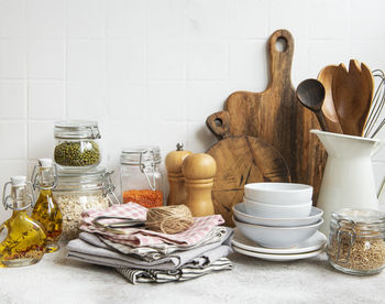 Kitchen utensils, tools and dishware on on the background white tile wall. i