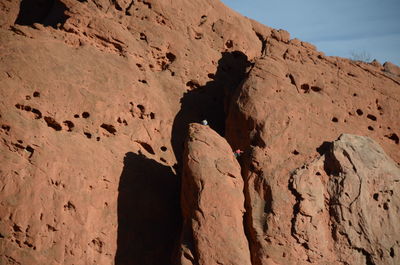 Low angle view of rock formation in desert against sky