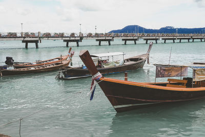 Boats moored in sea against sky