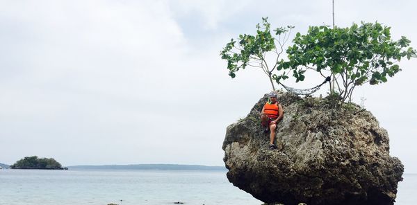 Scenic view of rock formation in sea against sky