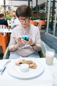 Young woman having food at restaurant