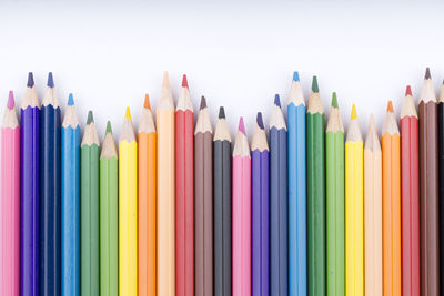 Close-up of colored pencils against white background