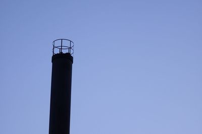 Low angle view of lighthouse against clear blue sky
