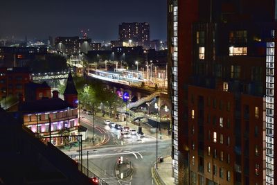 High angle view of city street and buildings at night