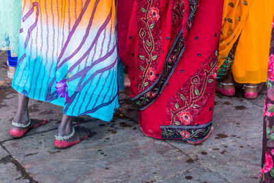 Low section of women standing on street