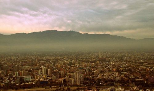 Cityscape against cloudy sky